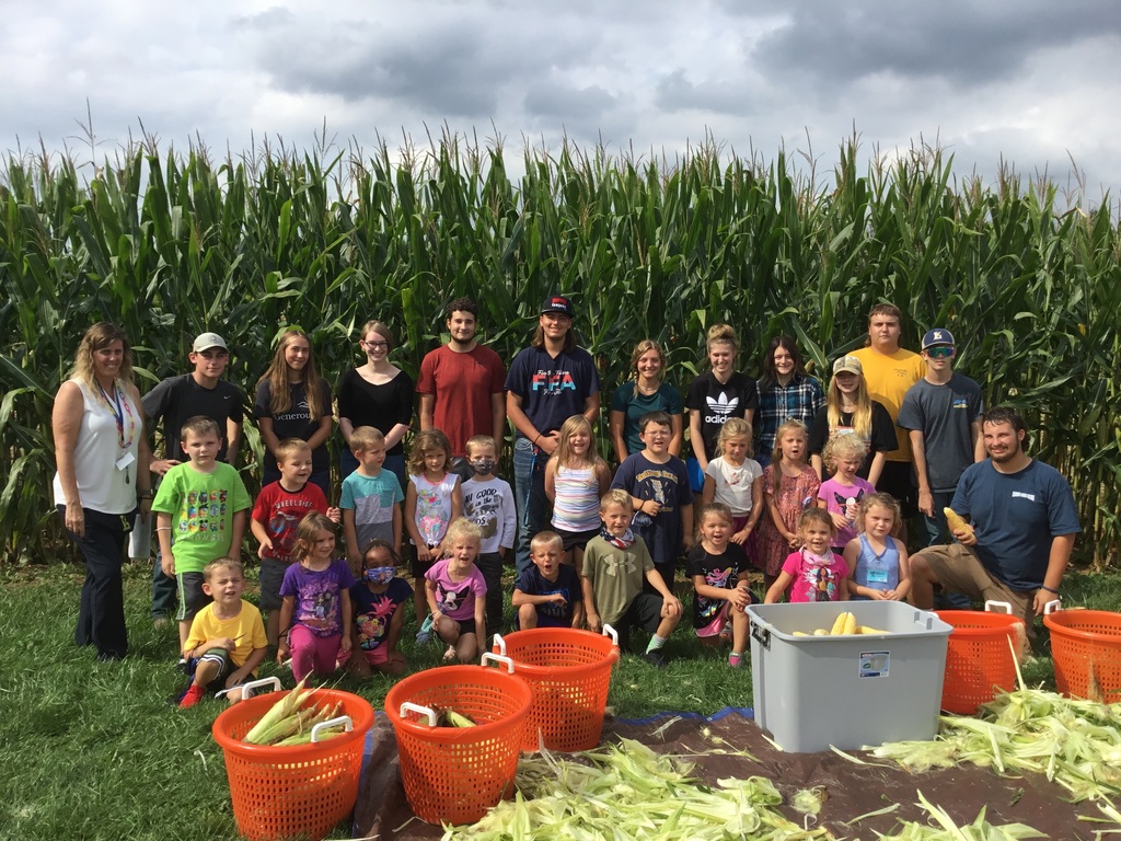 students in front of cornfield